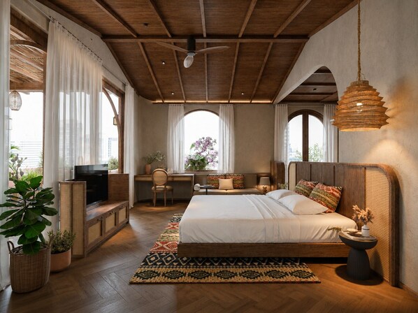 Une chambre avec un plafond en bois, un lit avec des oreillers, un bureau, une chaise et un luminaire suspendu.