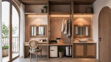 A modern bathroom with wooden accents, a large mirror, a sink, and a chair.