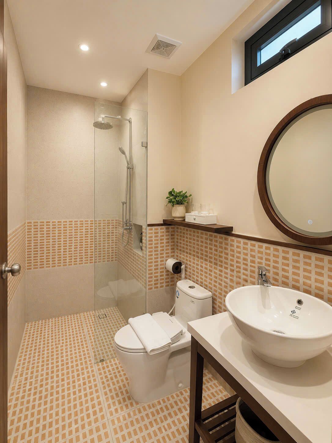Baño con ducha, inodoro, lavabo y espejo.