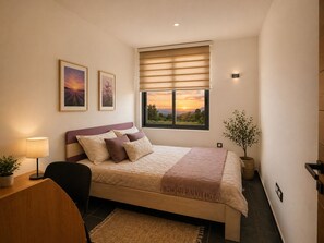 A bedroom with a bed, a desk, a chair, a window with a view, and a potted plant. - Luxury Hillside Villa with Pool, Terraces & Stunning Views (Gorno Sonje)