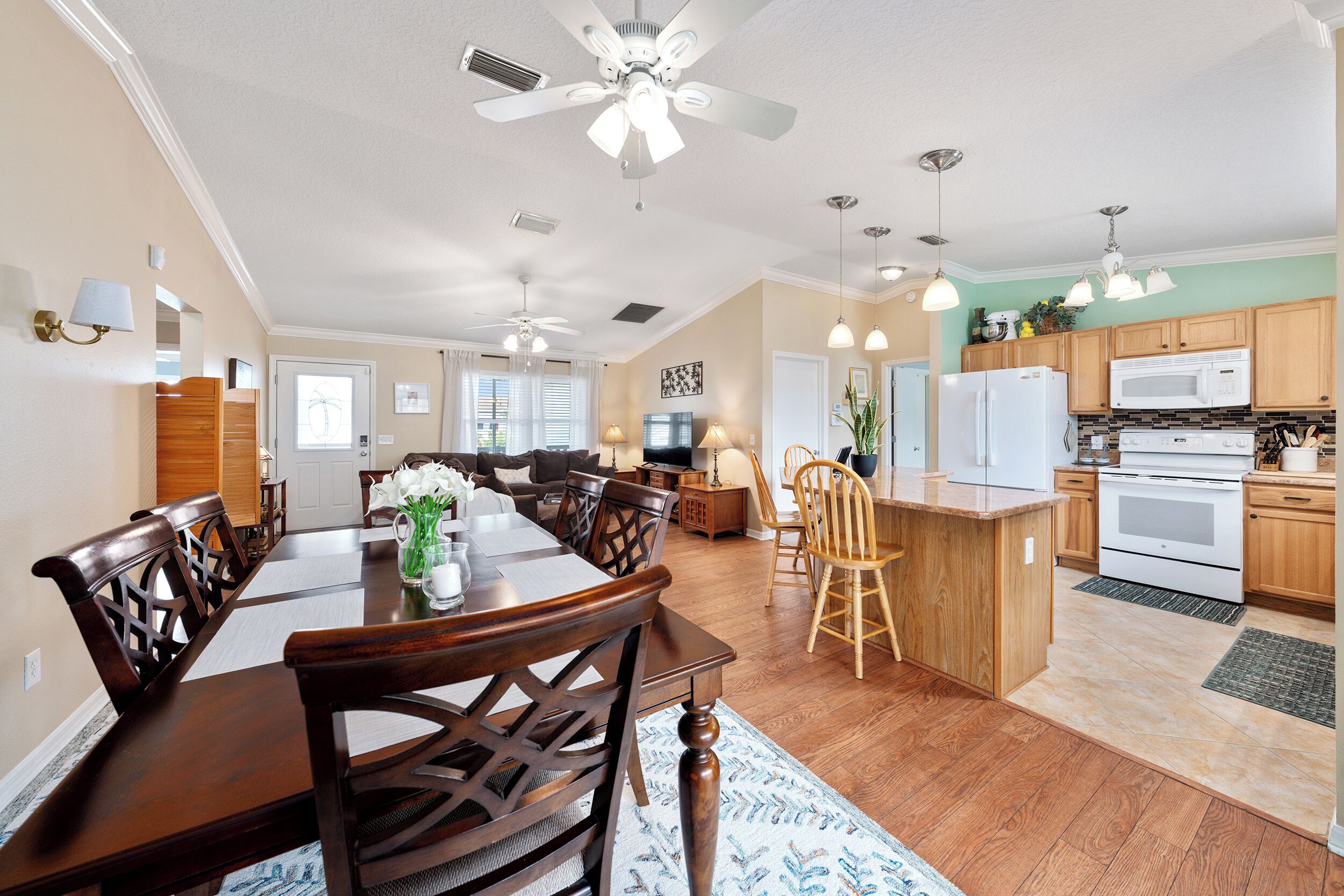 A spacious kitchen with wooden cabinets, a central island, and modern appliances.