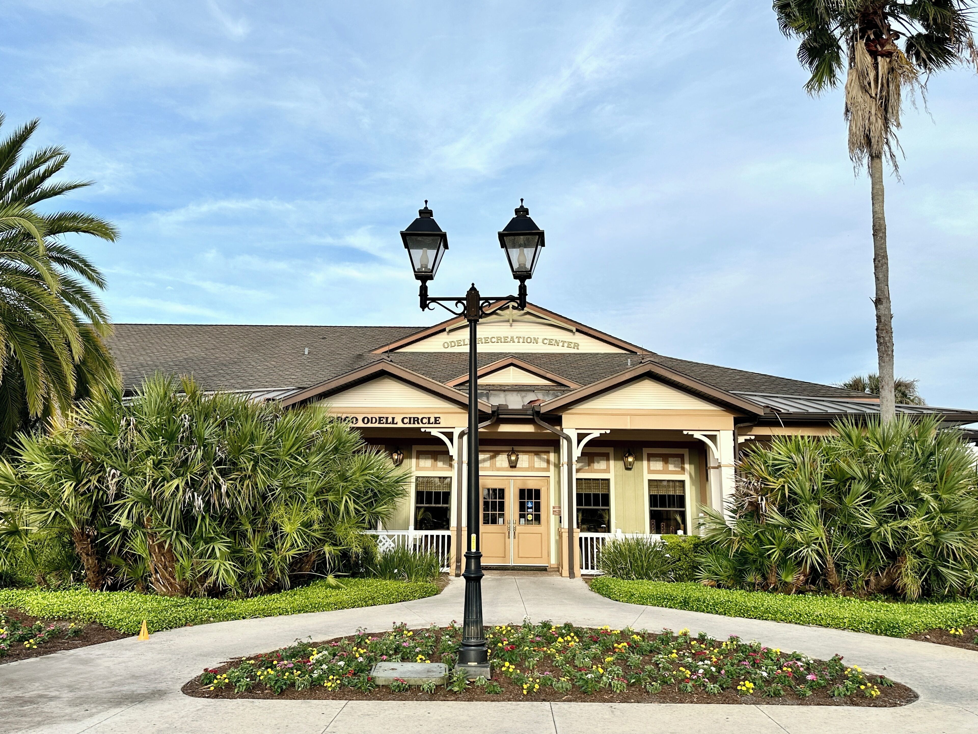 A building with a sign reading "Odell Recreation Center" and "Odell Circle" with a landscaped entrance and palm trees.