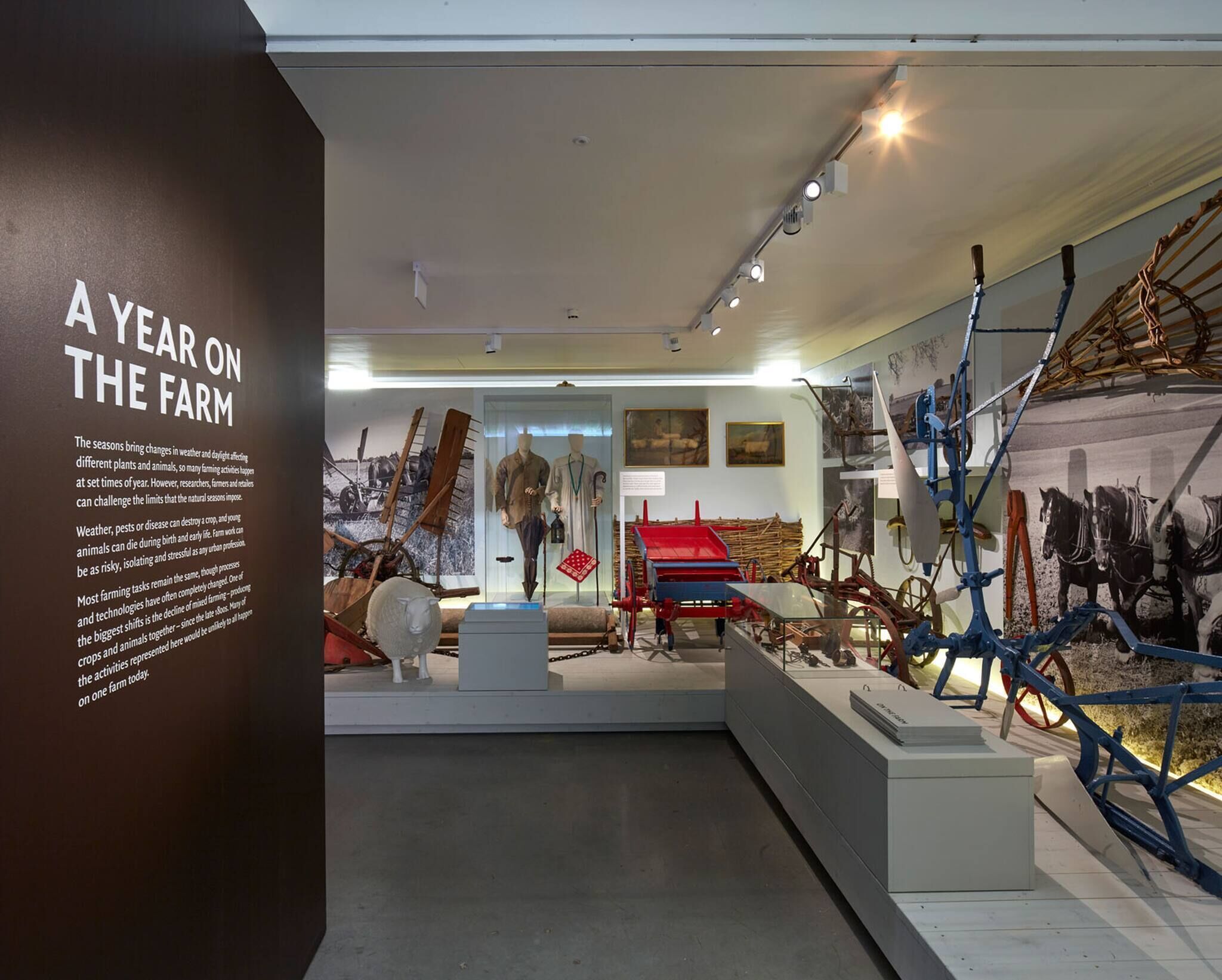 A museum exhibit titled 'A Year on the Farm' with historical farming equipment and mannequins.