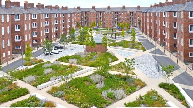 A residential area with brick apartment buildings, a central landscaped garden, and a paved walkway. - Cozy Apartment in Barrow-in-furness (Barrow-in-Furness)