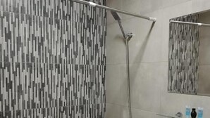 A bathroom with a shower, a sink, and a mirror. - Corner Hotel  (Yerevan)