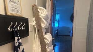 A hallway with a wooden coat rack, a towel rack, and a framed quote on the wall. - WELCOME to Pirates Harbor! Crab, fish & relax. Rare private boat launch  & hoist (Slidell)