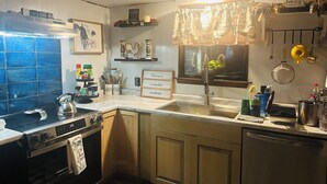 A kitchen with a stove, oven, sink, and various kitchen items. - WELCOME to Pirates Harbor! Crab, fish & relax. Rare private boat launch  & hoist (Slidell)