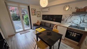A modern kitchen with a dining area, a large window, and a chalkboard wall. - City Oasis with Garden, BBQ, Pet-Friendly, near city center (Zagreb)