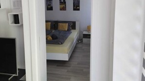 A bedroom with a bed, a desk, and a chair. There are three framed pictures on the wall. - City Oasis with Garden, BBQ, Pet-Friendly, near city center (Zagreb)