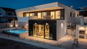 A modern two-story house with a swimming pool, large glass doors, and a balcony. - Villa Rossa Zadarvillas (Primosten)