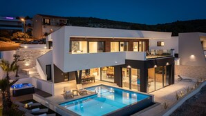 A modern two-story house with a swimming pool, outdoor seating, and a staircase leading to the upper floor. - Villa Rossa Zadarvillas (Primosten)