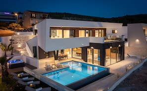 A modern two-story house with a swimming pool, outdoor seating, and a staircase leading to the upper floor. - Villa Rossa Zadarvillas (Primosten)