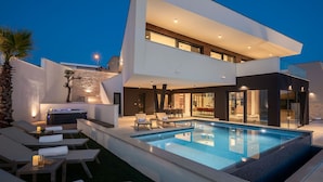 A modern two-story house with a swimming pool, outdoor seating, and a spa area. - Villa Rossa Zadarvillas (Primosten)
