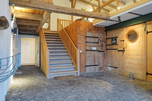 A wooden staircase leading to a loft area with a herringbone-patterned floor. - Haubarg Ossenhoff apartment for 6 persons near St.Peter-Ording (Tating)