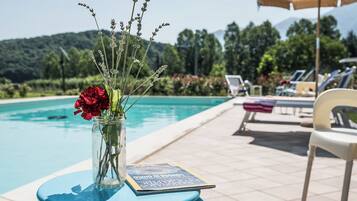 Seasonal outdoor pool, open 9:00 AM to 7:00 PM, pool umbrellas