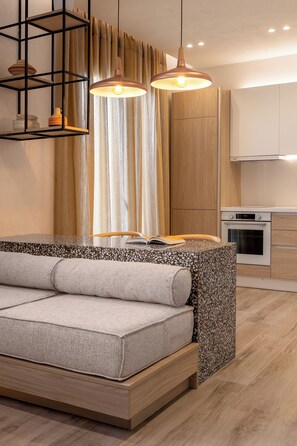 A modern living room with a sofa, a coffee table, and pendant lights. - Helena’s Retreat: Relaxation and Greek hospitality (Ρόδος)