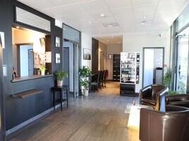 A modern lobby with a reception desk, seating area, and vending machines.