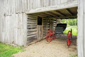 A rustic barn with a covered carriage area. - TBarnLoft@FF: Honeymoon, Outdoor Fireplace, Wifi, Water View, Large Yard (Cosby)