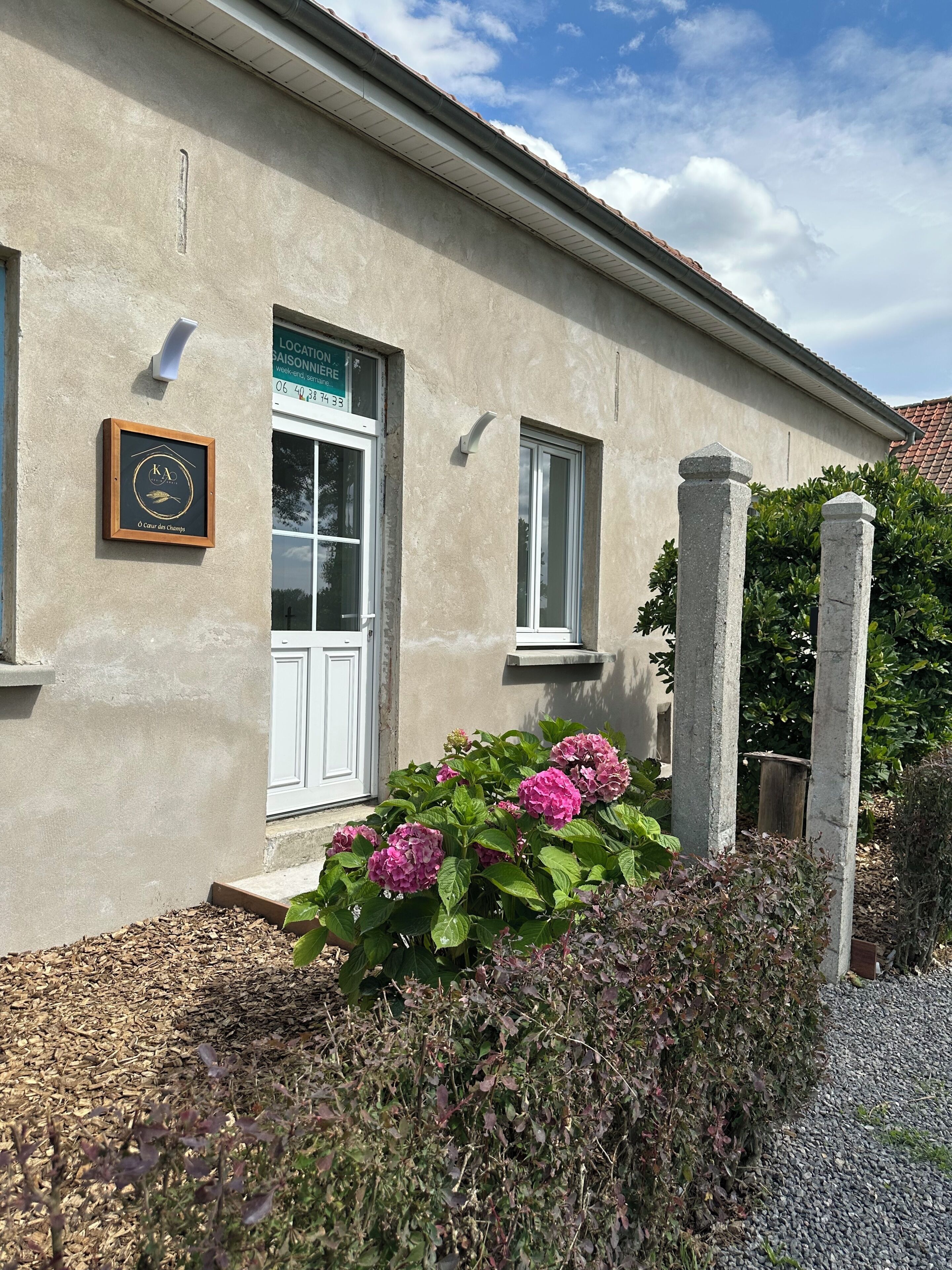 A building with a plaque, a window, and a door.