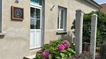 A building with a plaque, a window, and a door.