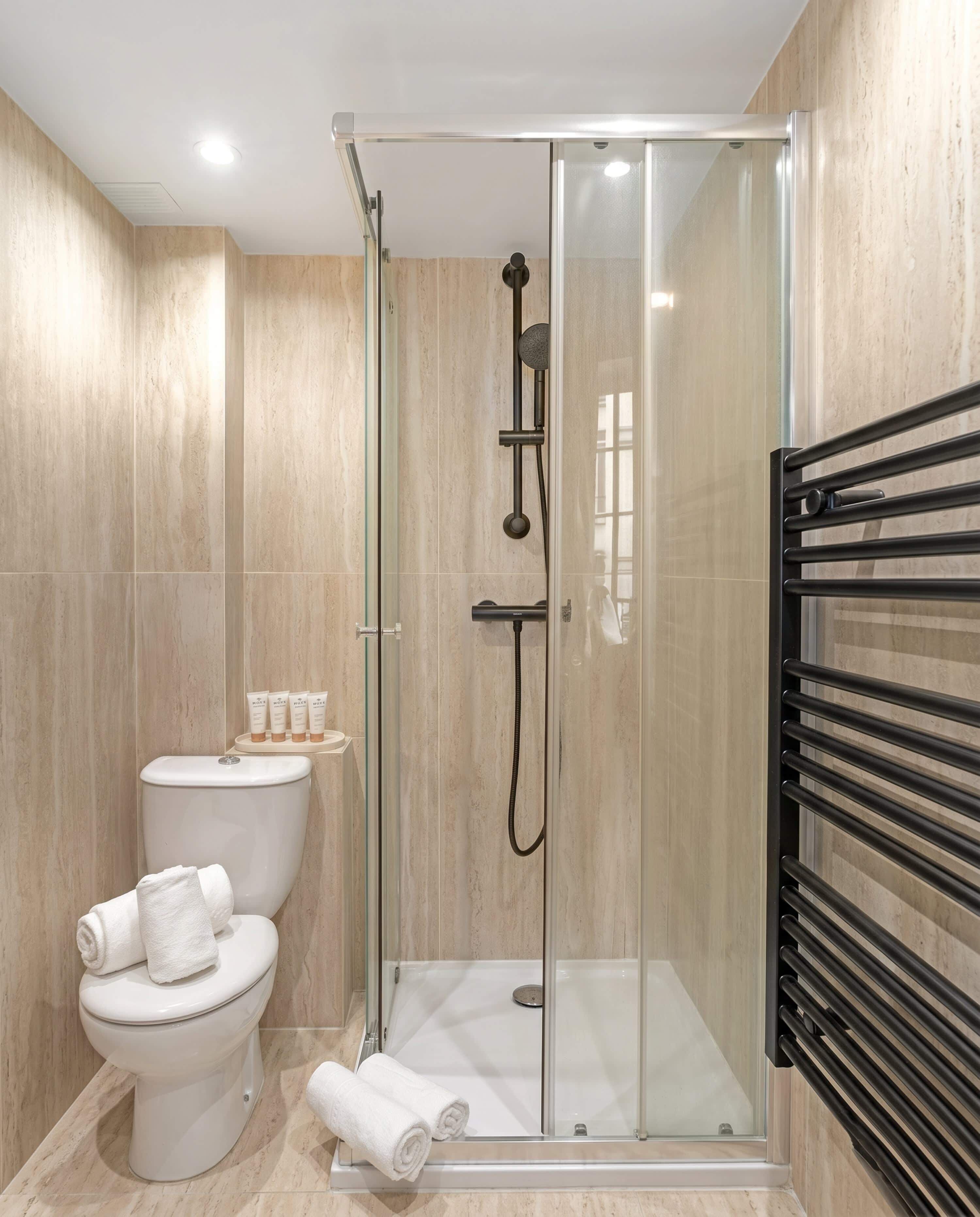 Shower, hair dryer, towels, shampoo