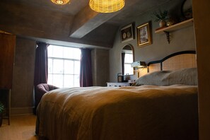 A bedroom with a large bed, a dresser, a mirror, and a window with curtains. - Cotswold Townhouse - Adults Only (Stow-on-the-Wold)