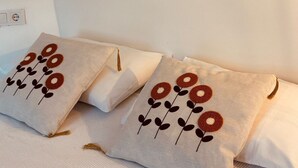 A bedroom with a bed, pillows, and three wall-mounted artworks. - Vita Nova Hotel (Kumluca)
