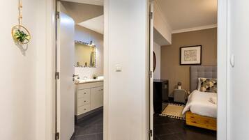 A bedroom with a bed, bedside table, and a headboard.