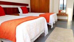 A hotel room with two beds, a wooden headboard, a large mirror, and a view of the outdoors. - Braga Restaurante e Residencial (Lourinha)