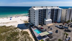 A multi-story hotel with a pool, beach access, and parking. - 2BR Beachfront retreat in Orange Beach w/ pools & tennis (Orange Beach)