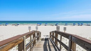 A wooden boardwalk leading to a beach with clear skies and no tents allowed. - 2BR Beachfront retreat in Orange Beach w/ pools & tennis (Orange Beach)