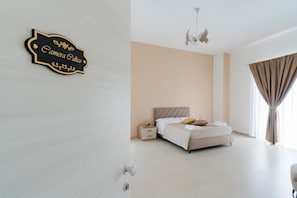 Un dormitorio moderno con cama, mesita de noche y un cartel en la pared.