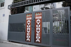 A gated entrance with signs reading 'AYURVEDA' and 'AYURVEDA'. - Ayuskama Ayurveda Ayur Yoga (Rishikesh)