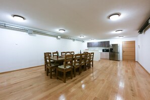 A spacious kitchen with wooden flooring, a dining table with chairs, and modern appliances. - Villa Lubey 2 Zadarvillas (Razanac)