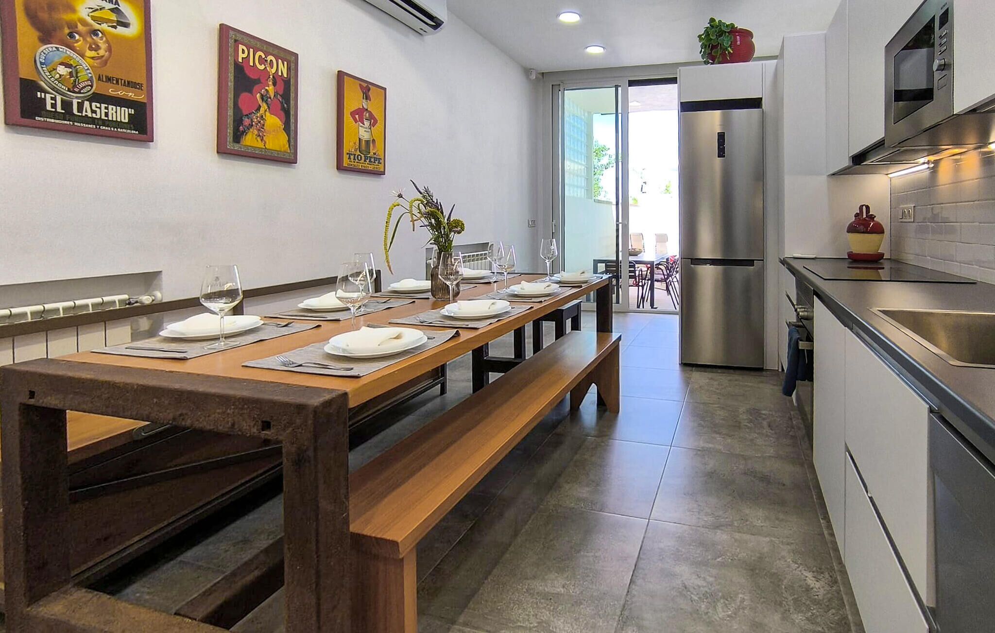 A modern kitchen with a stainless steel refrigerator, a microwave, and a sink.