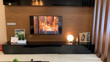 Deluxe Apartment, City View | Living area | 43-inch LED TV with digital channels
