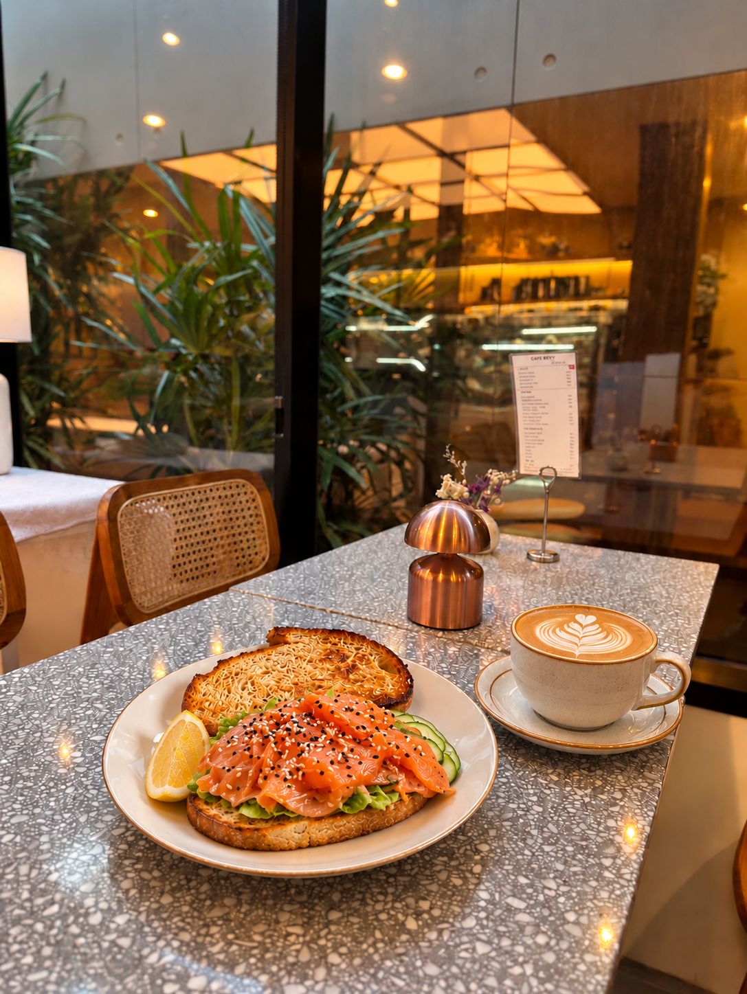 A table with a plate of food, a cup of coffee, and a menu sign.
