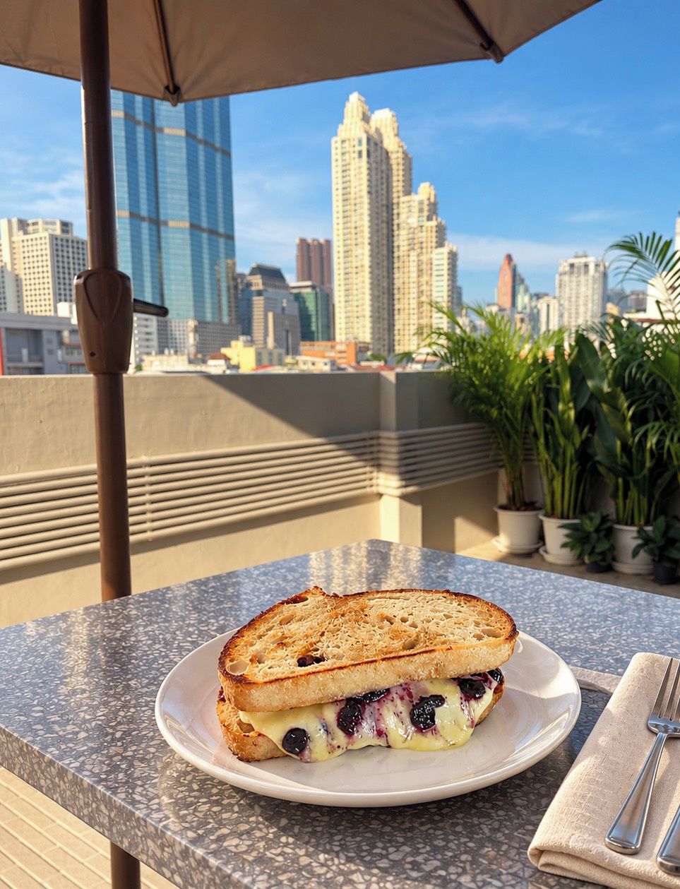 A sandwich on a plate with a city skyline in the background.