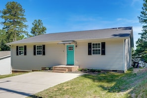 A single-story house with a front door, a small porch, and a clear sky. - NEW Ranch Home By Duke Hospital & UNC Hospitals (Durham)