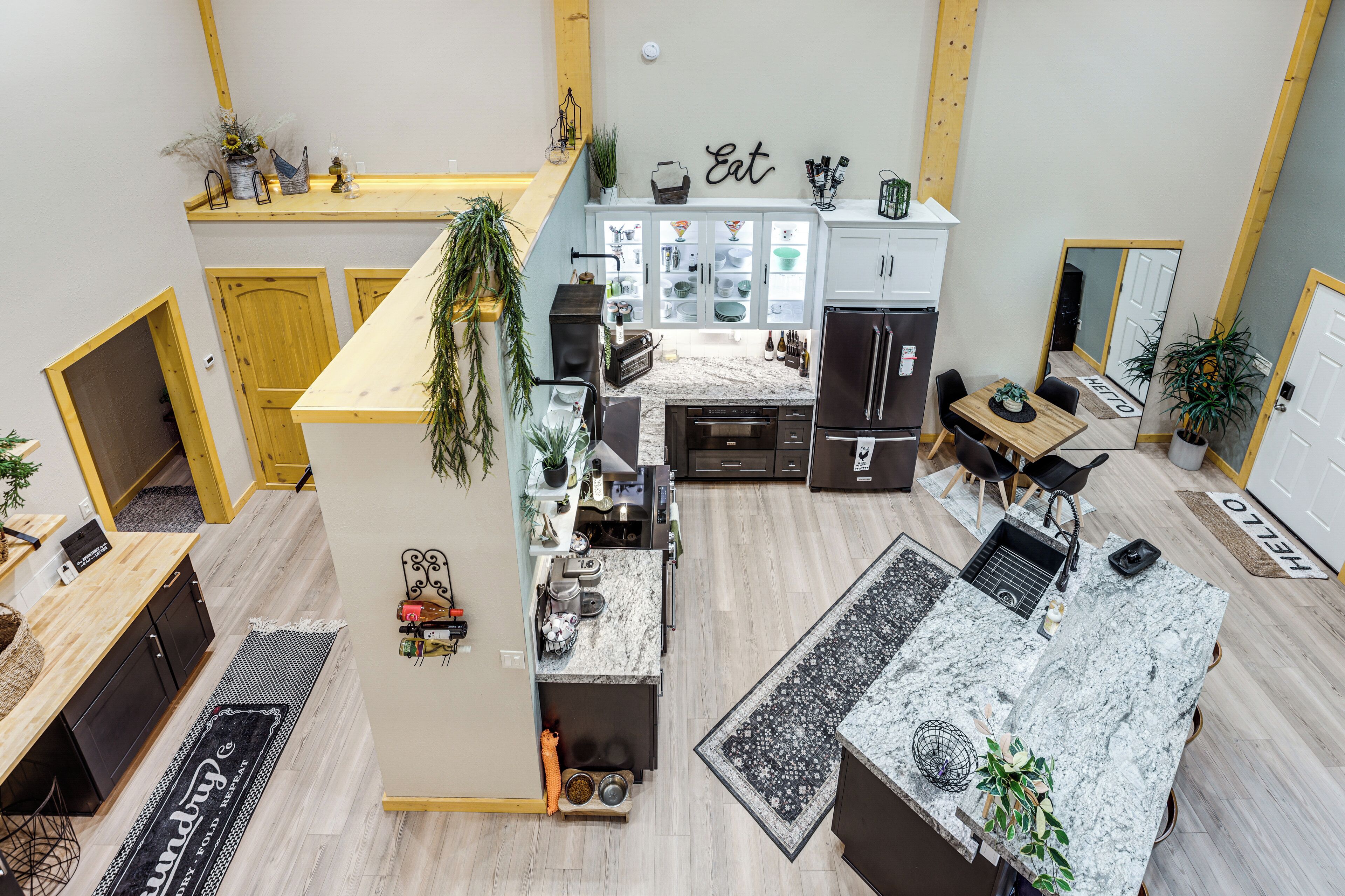 A modern kitchen with granite countertops, a dining area, and a small dining table.