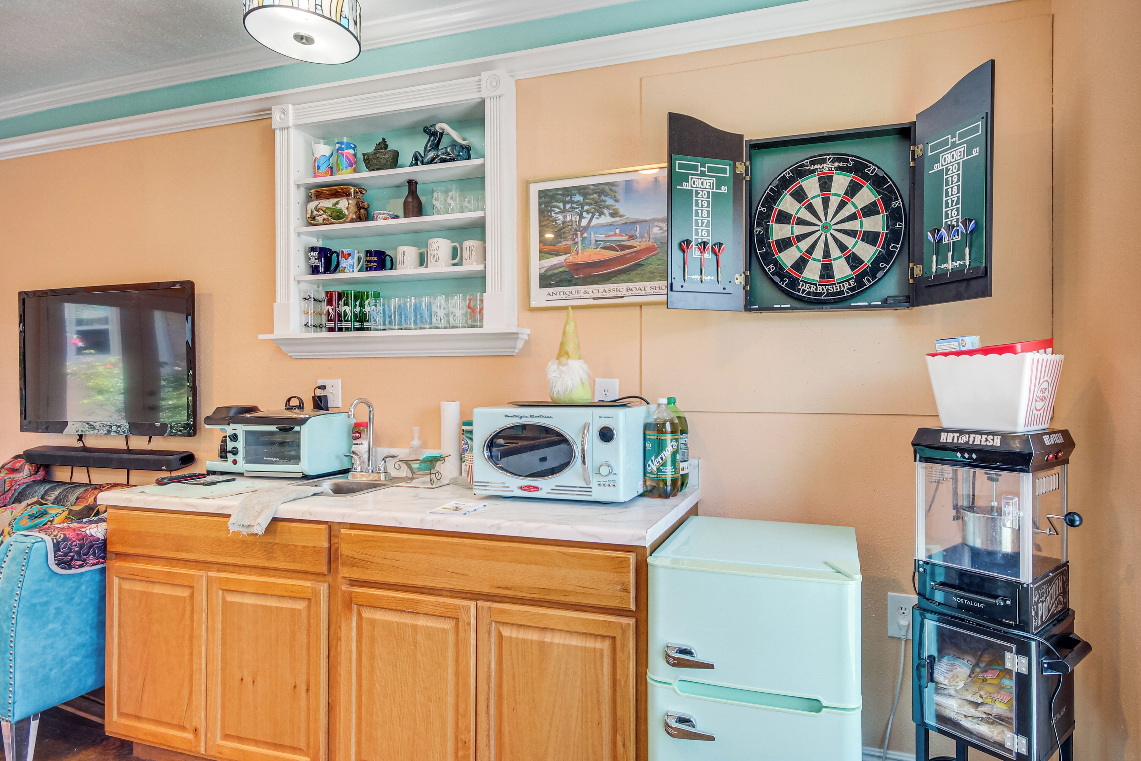 A kitchen with a microwave, toaster, and refrigerator.