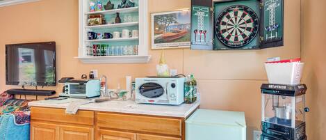 A kitchen with a microwave, toaster, and refrigerator.