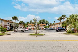 A residential street with houses, parked cars, and palm trees. - Centrally Located! Brand New South Daytona Retreat (Daytona Beach)