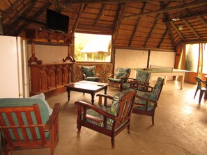 A room with wooden furniture, a pool table, and a television mounted on the wall. - Mafube Mountain Retreat (Fouriesburg)