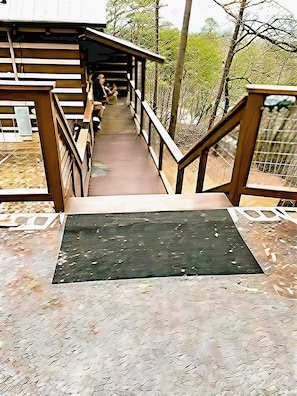 A wooden bridge leading to a covered area with benches, surrounded by trees. - Blu's Blessed View 1 Bedroom Cabin (Sevierville)