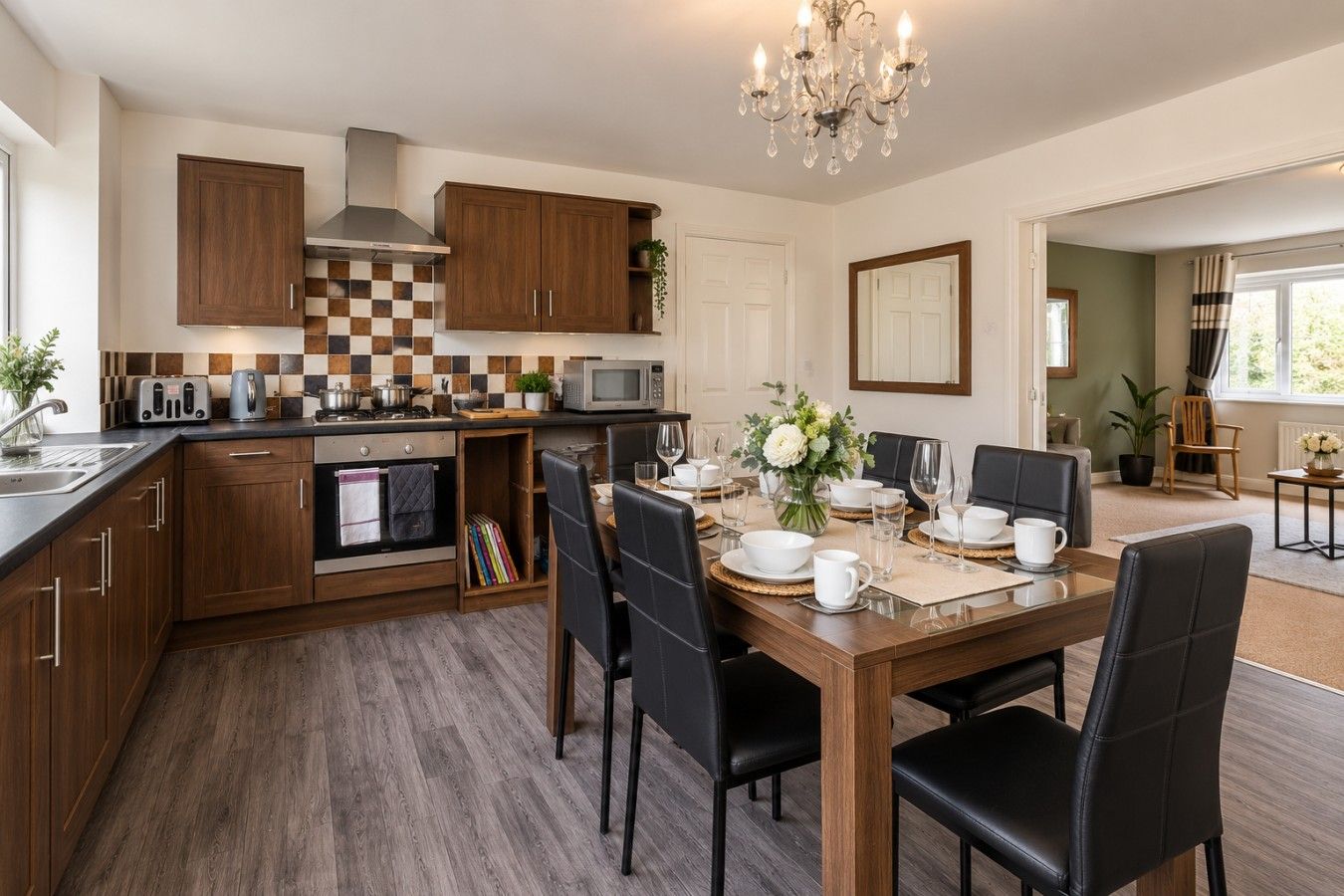 A modern kitchen with wooden cabinets, a dining area with a table set for six, and a chandelier.