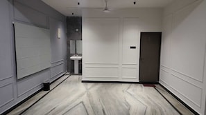 A hallway with a white door, a sink, and a mirror. - Shangov Farms Shamirpet (Shamirpet)
