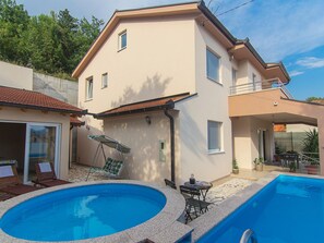 A two-story house with a swimming pool, a balcony, and a patio area with outdoor furniture. - Holiday Home Vele With Pool (Vrgorac)