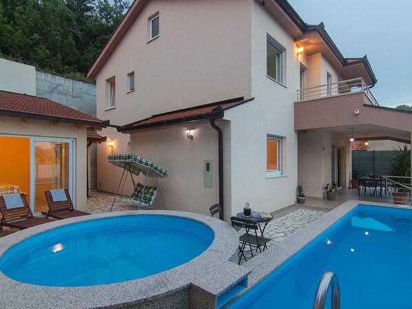 A two-story house with a swimming pool, outdoor seating, and a balcony. - Holiday Home Vele With Pool (Vrgorac)