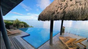 A pool with a thatched roof, lounge chairs, and a view of the sea. - Raitotoka Eco Resort- Double or twin room with private bathrroom (Matei Taveuni)